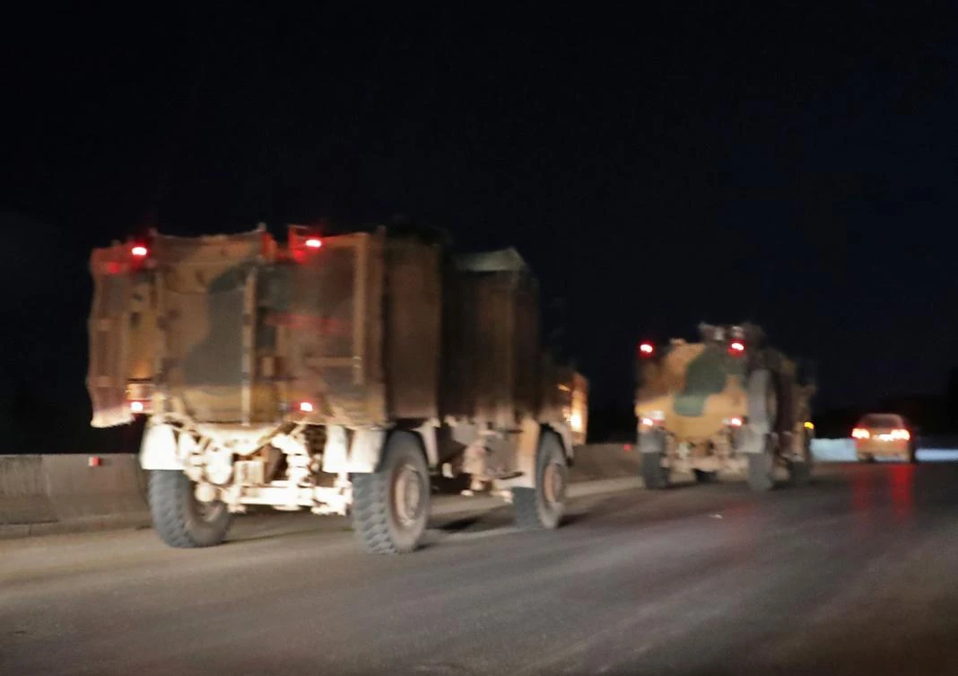 Turkish military vehicles drive southwards in a column along the main Damascus-Aleppo highway near the town of Saraqib in Syria's mostly rebel-held northern Idlib province. (AFP)
