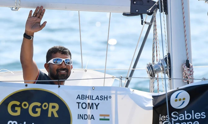 In this file photo taken on July 01, 2018 India's Abhilash Tomy gestures on his boat "Thuriya" as he sets sails from Les Sables d'Olonne Harbour at the start of the solo around-the-world "Golden Globe Race" ocean race in which sailors compete without high technology aides such as GPS or computers. (AFP)