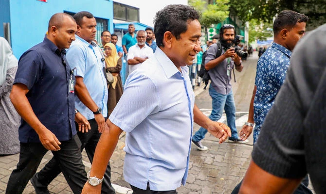 In this Sunday, Sept. 23, 2018 photo, Maldivian president Yameen Abdul Gayoom, center, leaves a polling station after casting his vote during presidential election day in Male, Maldives. (AP)