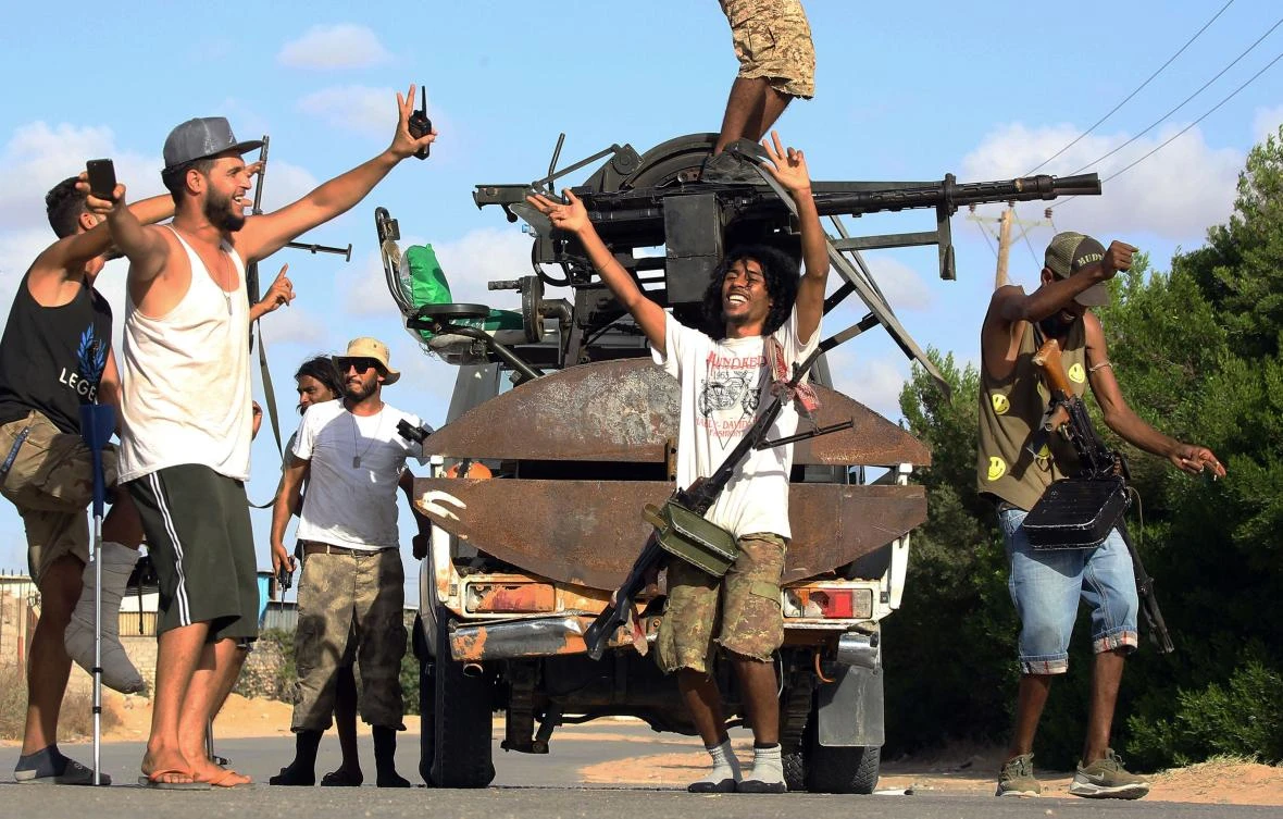 Libyan militiamen loyal to the Government of National Accord (GNA), Libya’s internationally recognized government, celebrate their advances on the field in the south of the Libyan capital Tripoli on September 25, 2018. (AFP)