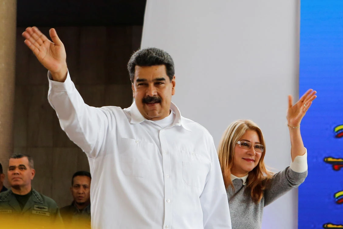 Nicolas Maduro attends an event for migrants living in Venezuela with his wife Cilia Flores, in Caracas. The US has announced sanctions against Maduro’s wife. (Reuters)