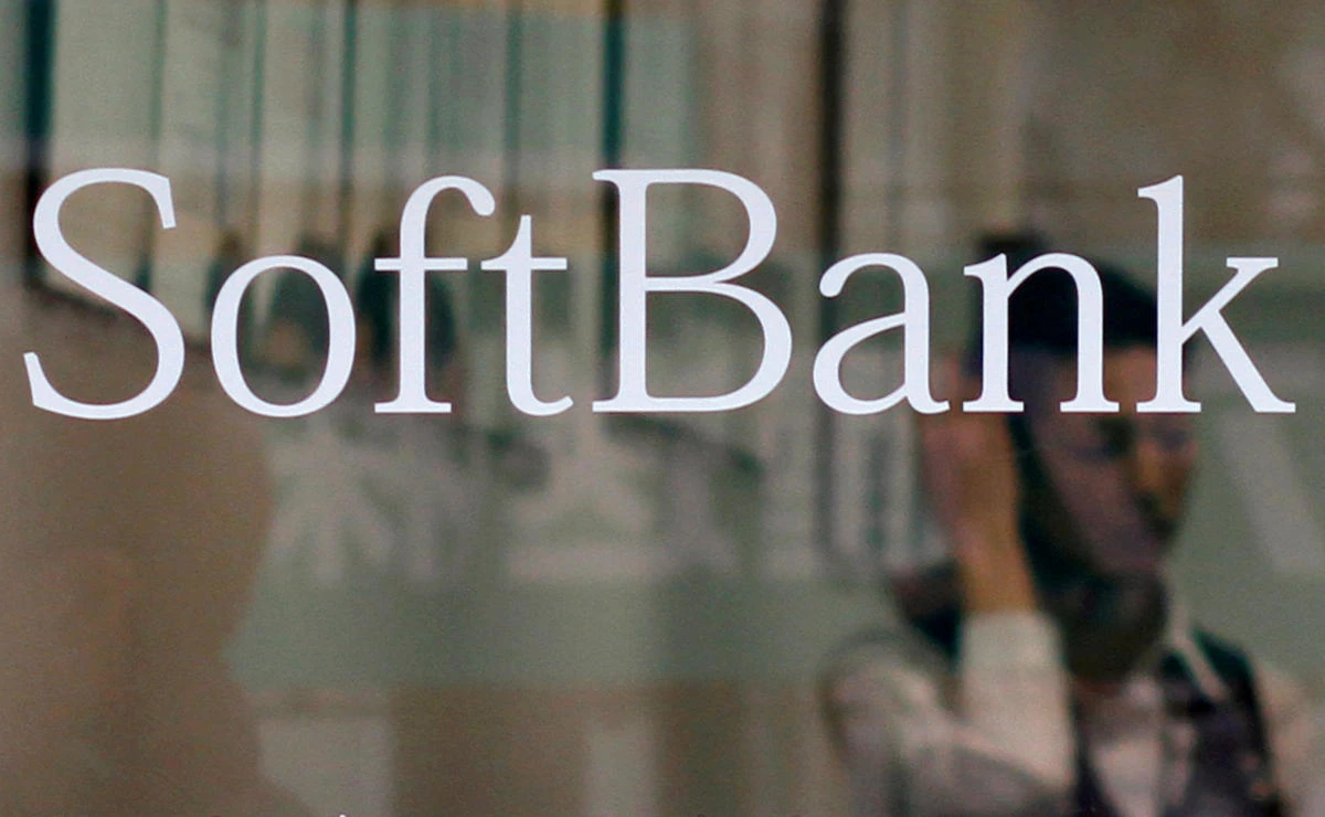 An employee works behind a logo of Softbank Corp at its branch in Tokyo March 2, 2011. (Reuters)