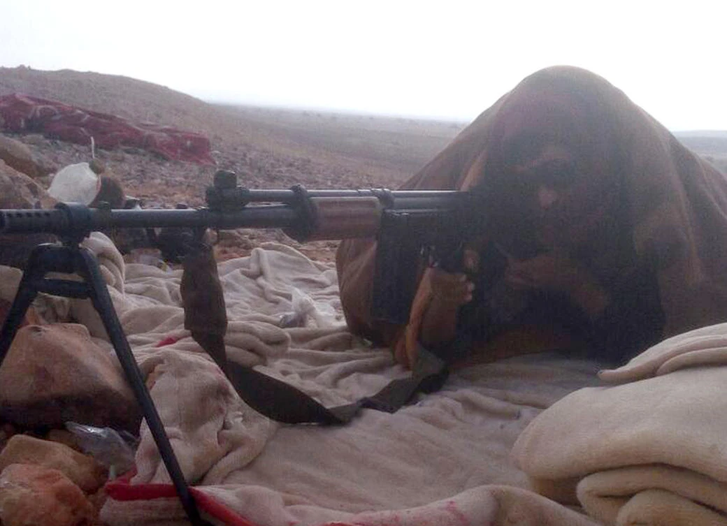 A Bedouin from the Tayaha tribe aims his weapon during an operation accompanying the Egyptian military in Central Sinai, Egypt. (AP)