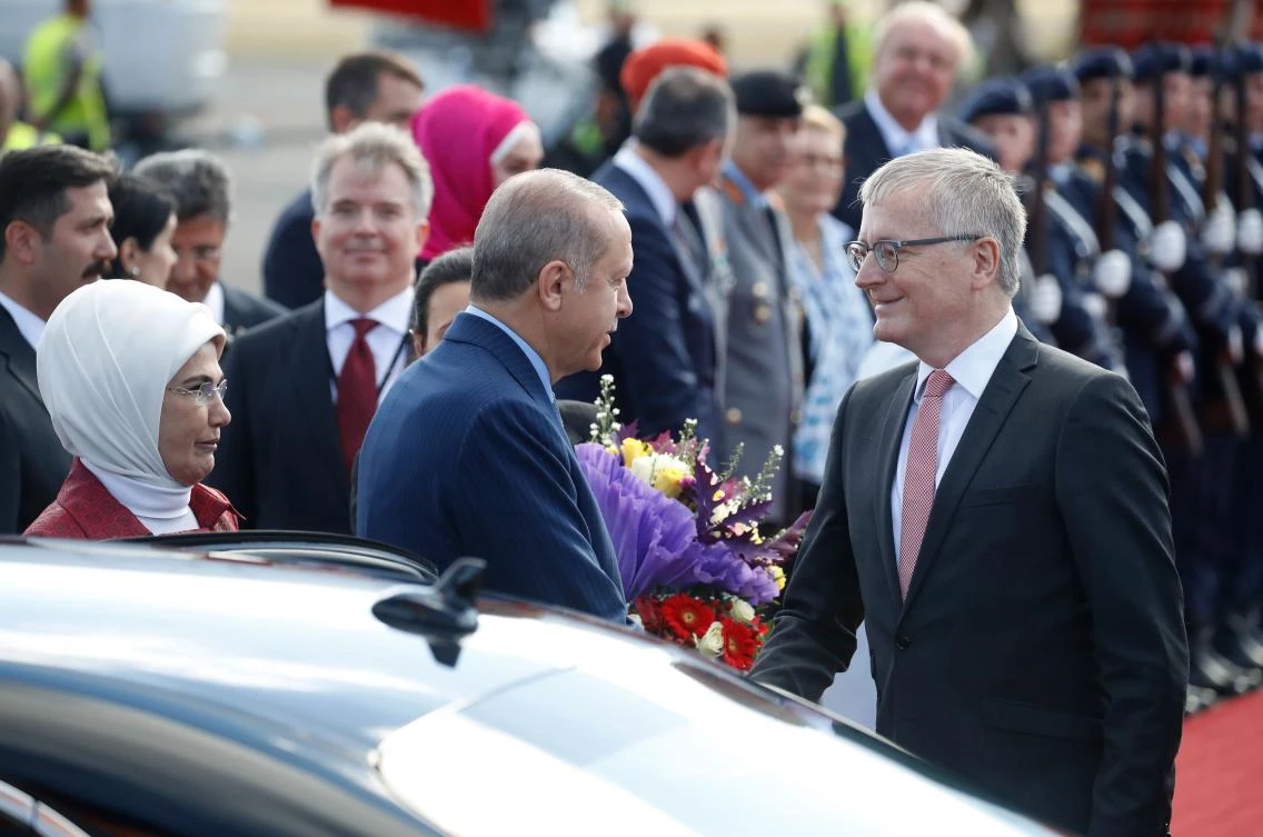Turkish President Recep Tayyip Erdogan (C) and his wife Emine Erdogan (L) are welcomed by Stephan Steinlein (R), chairman of the Office of the Federal President of Germany, after landing at Berlin’s Tegel airport on September 27, 2018. (AFP)