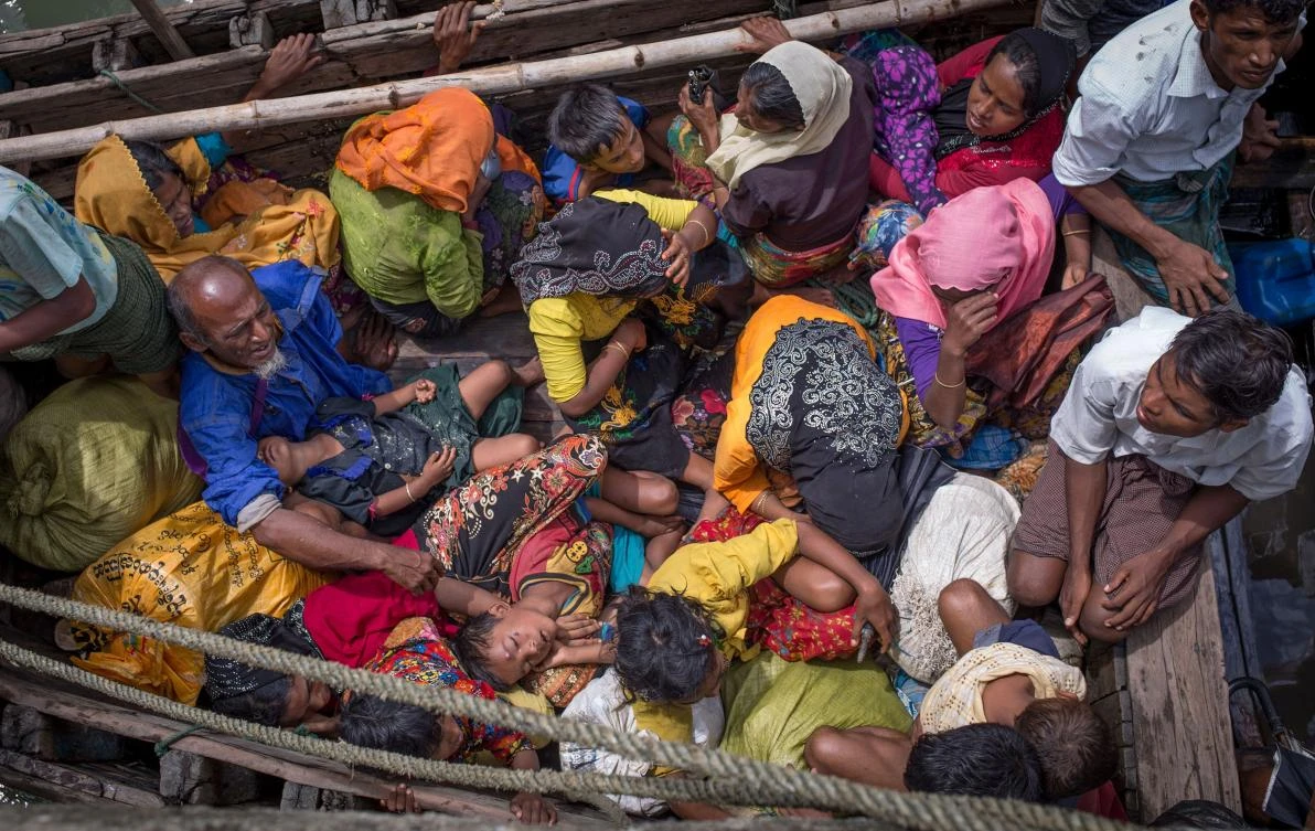 This file photo shows Rohingya refugees arriving by boat at Shah Parir Dwip on the Bangladesh side of the Naf River after fleeing violence in Myanmar. (AFP)