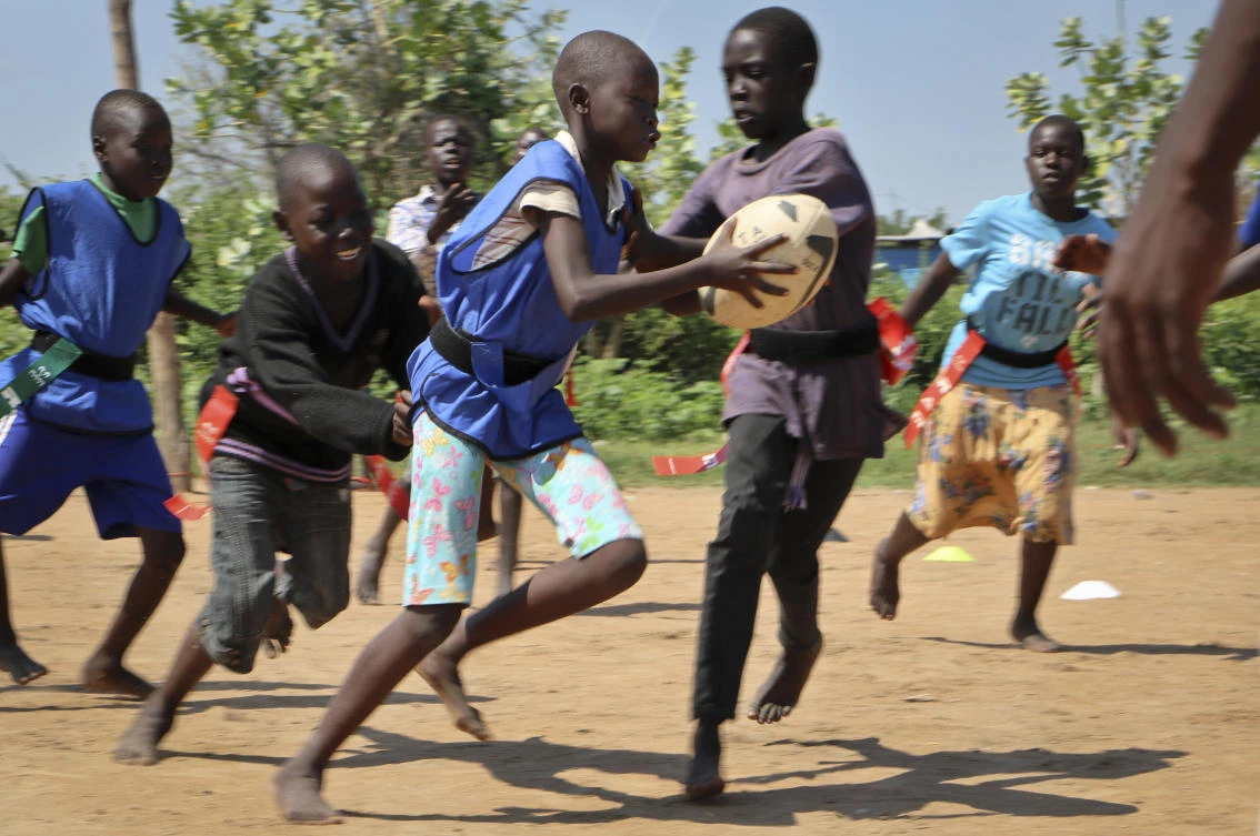 In this photo taken Saturday, Sept. 1, 2018, 11-year-old rugby player Gloria Nene clutches the ball as she runs to score a try during the South Sudan Rugby Club's weekly practice in Juba, South Sudan. (AP)