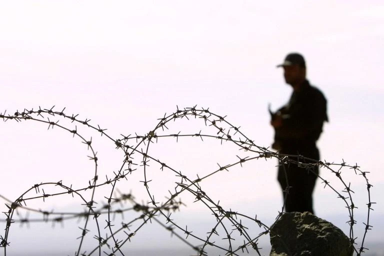 Above, an Iranian soldier stands guard on the point where the borders of Iran, Afghanistan and Pakistan meet in this December 2003 photo. (AFP)