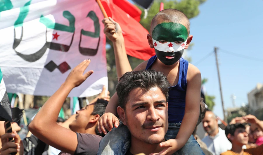 Syrians take part in an anti-regime demonstration in the opposition-controlled town of Maaret Al-Numan, Idlib. (AFP)