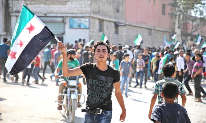 Youngsters take part in an anti-regime demonstration in Idlib. (AFP)