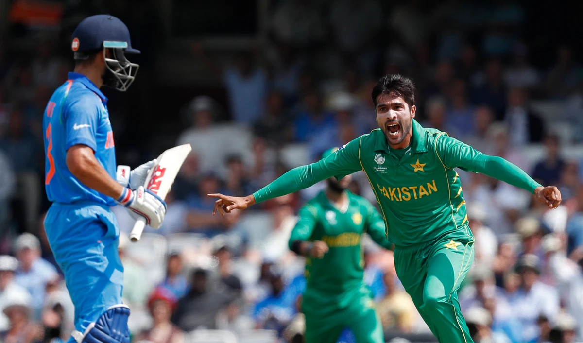 In this file photo, Pakistan's Mohammad Amir, right, celebrates after taking the wicket of India's captain Virat Kohli during the ICC Champions Trophy final cricket match between India and Pakistan at The Oval in London on June 18, 2017. (AFP)