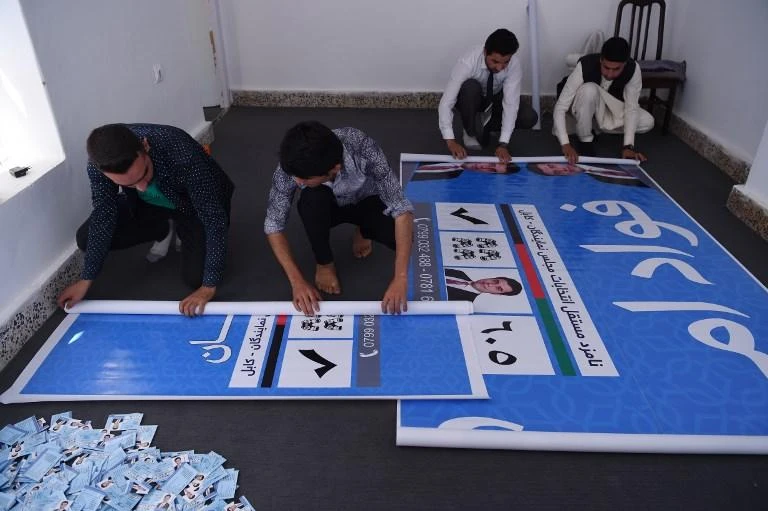 A team of parliamentary election candidate Fawad Aman prepares election campaign posters in Kabul, amid a crescendo of deadly violence ahead of Afghanistan’s long-delayed parliamentary elections. (AFP)