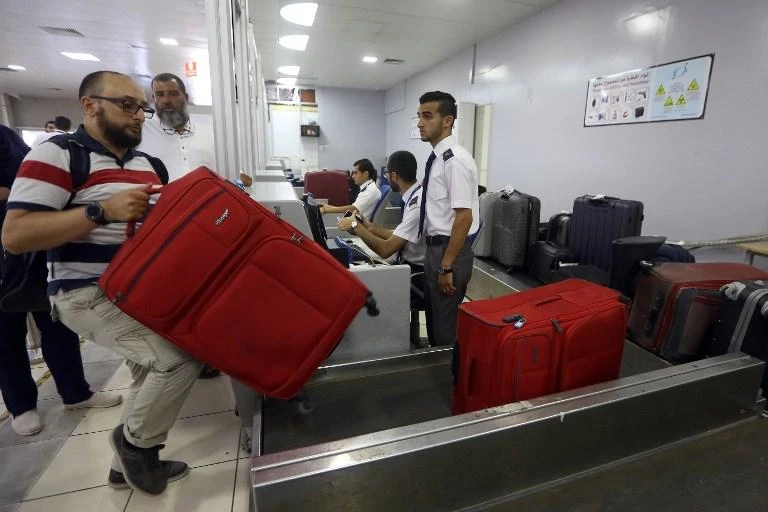 Travelers check-in at the Mitiga International Airport after its reopening early last month. (AFP)
