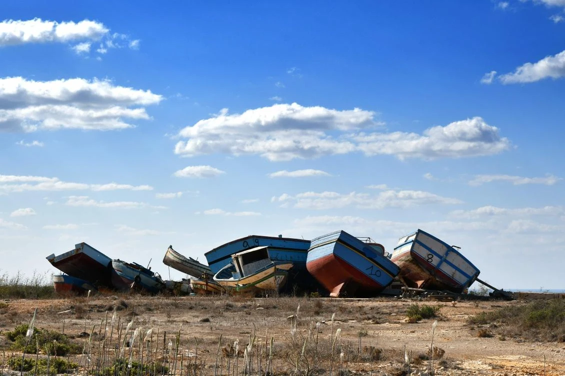 The so-called boat cemetery, where skiffs are dumped after the migrants and refugees' crossing from North Africa, is pictured in Lampedusa on September 27, 2018. (AFP)