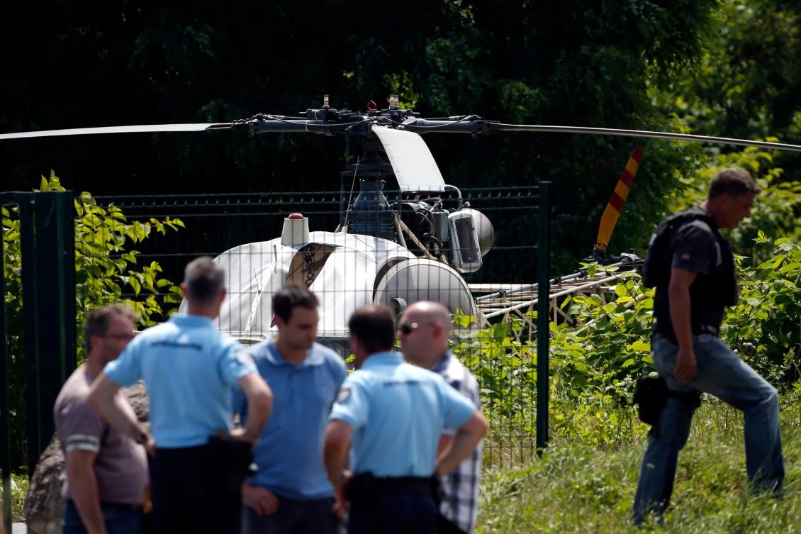 Police guard French helicopter Alouette II abandoned by armed robber Redoine Faid after his escape from prison in Reau in July. (AFP)