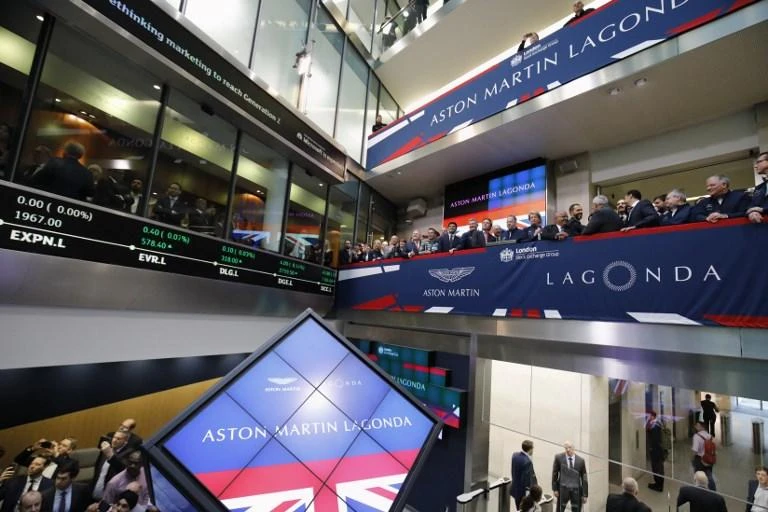 Top officials from Aston Martin stand by as the luxury British sports car manufacturer is floated on the London Stock Exchange on Wednesday, October 3. (AFP)