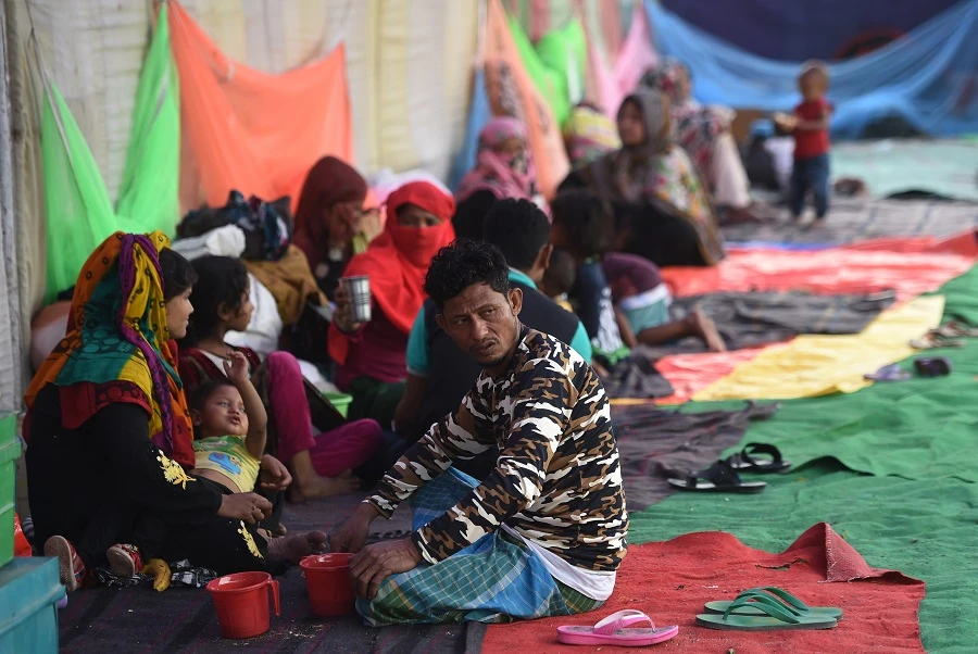 Rohingya refugees rest at a temporary shelter in New Delhi, following a fire that broke out at their camp. (AFP)