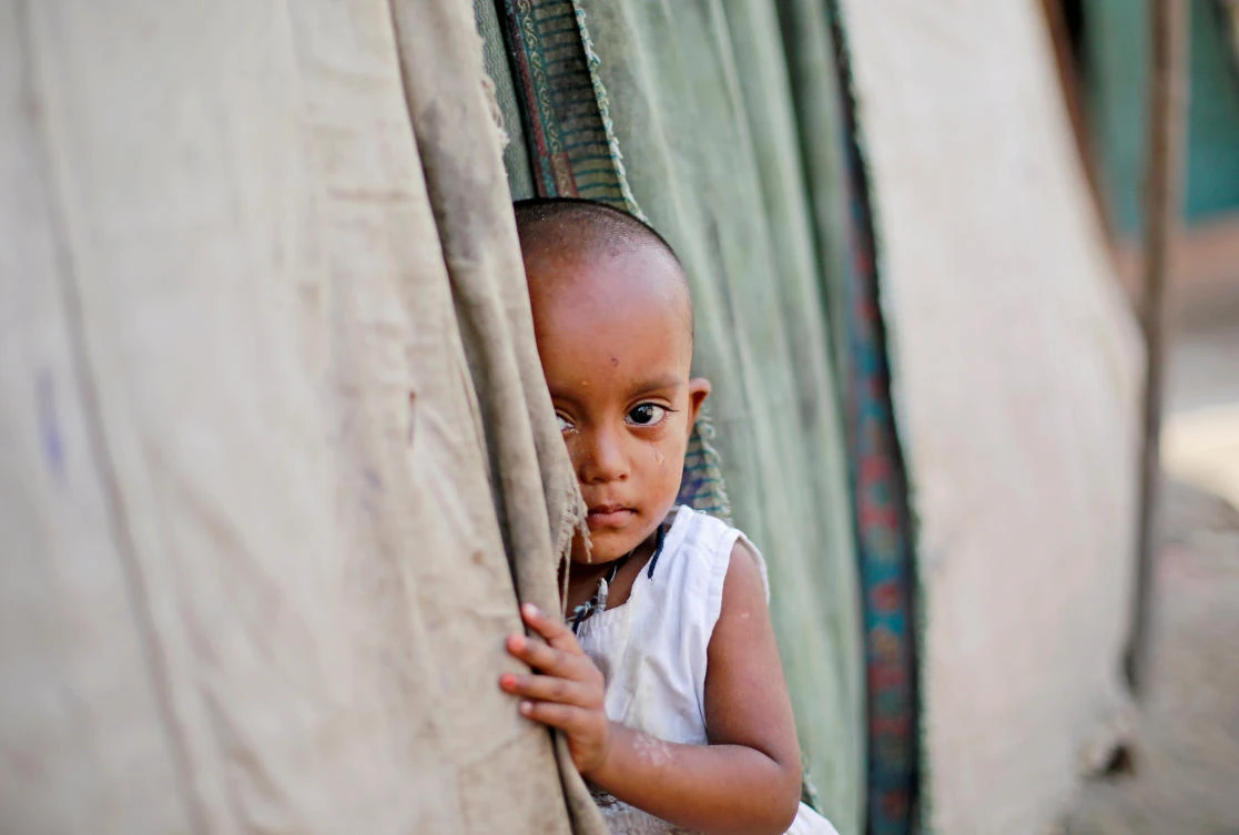 A girl from the Rohingya community stands outside her family's shack in a camp in New Delhi, India October 4, 2018. (Reuters)