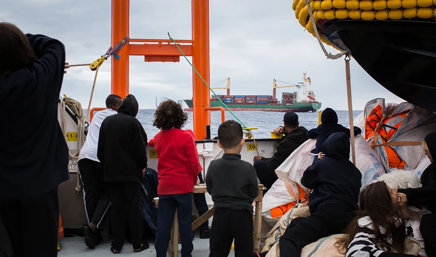 In this Sept. 29, 2018 photo, migrants are seen aboard the Aquarius rescue ship run by non-governmental organizations SOS Mediterranee and Medecins Sans Frontieres in the search and rescue zone off the coast of Libya, in the Mediterranean Sea. (SOS Mediterranee via AFP)