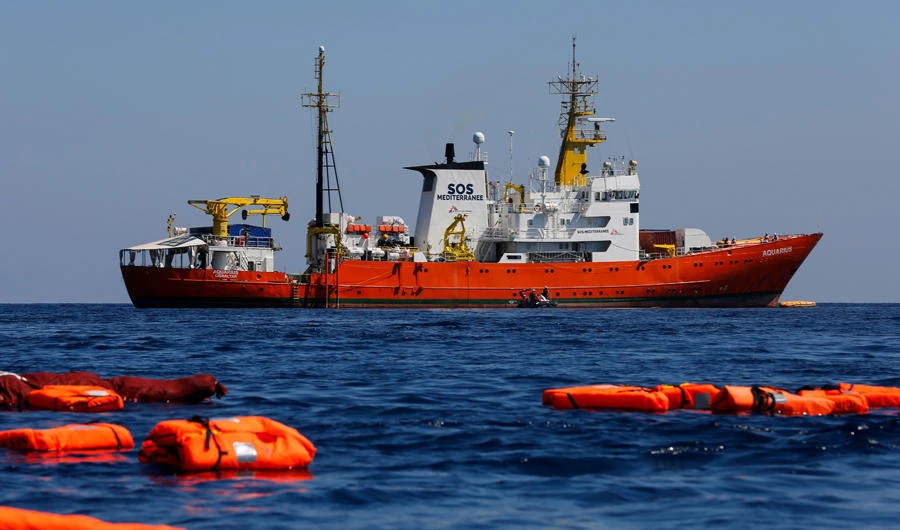 The Aquarius rescue vessel, chartered by French NGO SOS-Mediterranee and Doctors Without Borders (MSF), is seen during a rescue drill at open sea on June 23, 2018 in the central Mediterranean Sea. On Thursday, the Italian-flagged rescue ship Mare Jonio set sail for the deadly migrant smuggling route, challenging moves by Italy’s populist government to shut down such humanitarian operations. (AFP / PAU BARRENA)