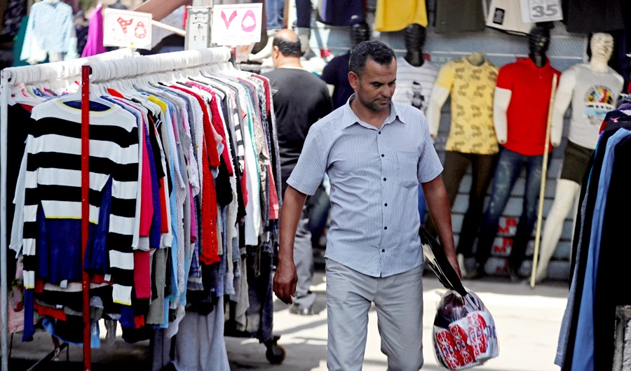 A man walks at a clothes market in Cairo, Egypt, on Sept. 13, 2018. (REUTERS)