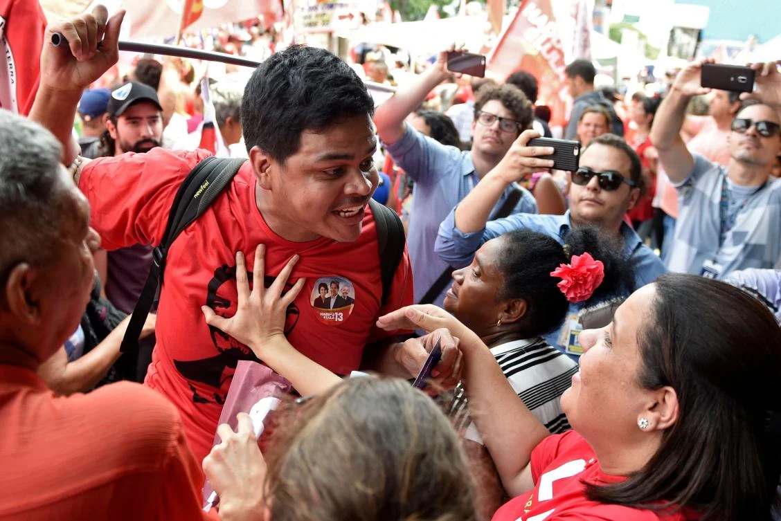 A supporter (L) of Brazilian presidential candidate for the Workers’ Party (PT) Fernando Haddad argues with supporters (R) of Brazilian presidential for the Social Liberal Party (PSL) Jair Bolsonaro, during a PT campaign rally in Belo Horizonte, Minas Gerais state, Brazil, on Oct. 5, 2018, ahead of Sunday’s election. (AFP/Douglas Magno)
