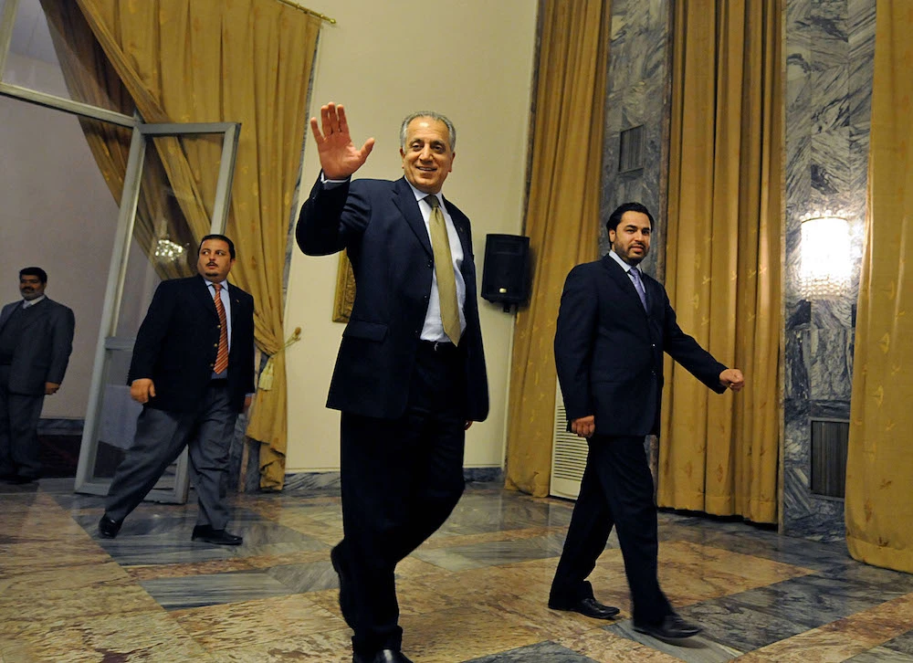 Afghan-born senior US envoy Zalmay Khalilzad (2-R) waves to media representatives as he walks prior to a meeting at the Foreign Ministry in Kabul. (File photo / AFP)