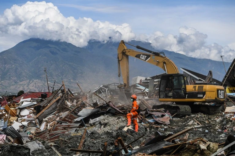 A search and rescue team uses heavy equipment to recover bodies from the debris as hopes of finding anyone alive have fade. (AFP)