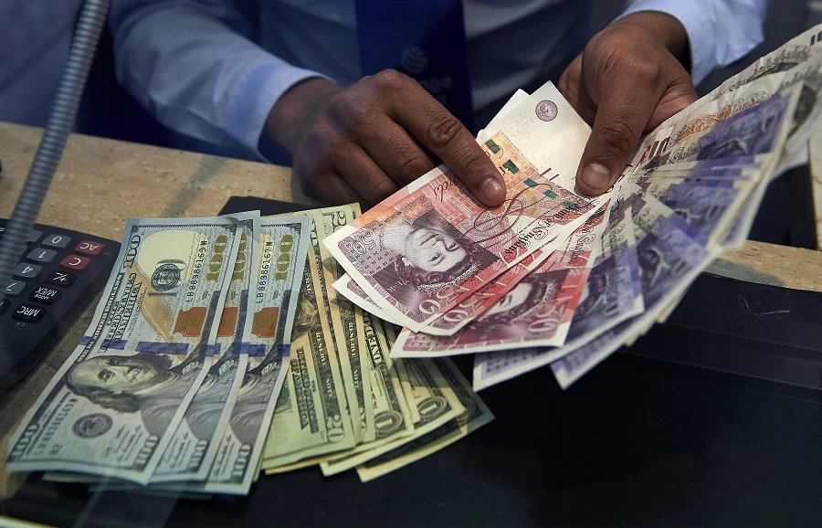 Sterling drops as dollar gains, caution sets in after Brexit deal optimism