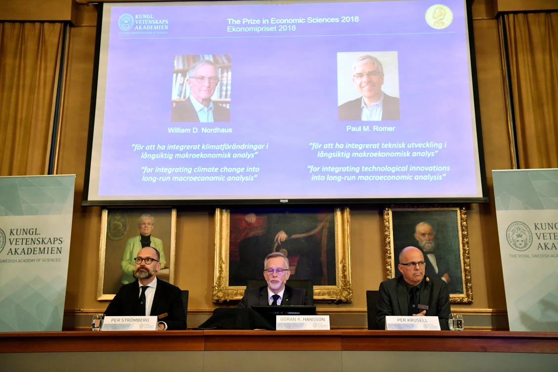 The images of William D. Nordhaus och Pau M. Romer are projected on the screen during the announcement of winners for the Nobel Prize in Economics on Monday, October 8. (TT News Agency via Reuters)