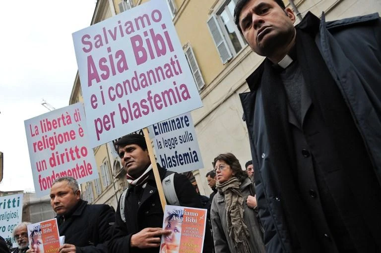 Protesters hold posters reading “Religious Freedom is a Fundamental Right”, “Let’s save Asia Bibi and all those condemned for blasphemy” during a demonstration in front of the Italian parliament on January 26, 2011. (AFP)