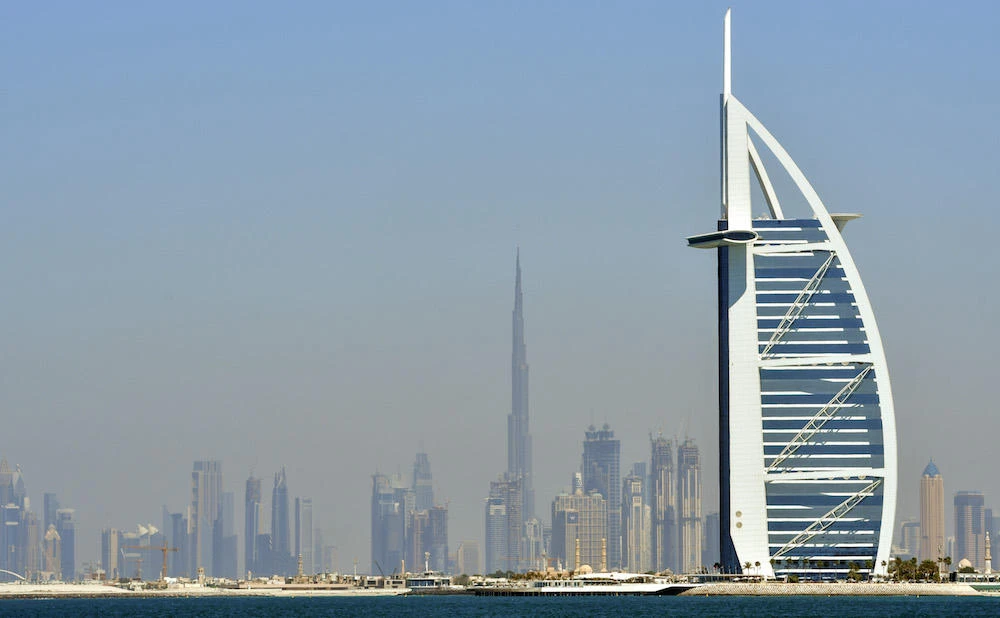 A picture taken on March 14, 2018 shows the skyline of Dubai with the Burj Al-Arab (R) in the foreground and Burj Khalifa (L) in the background. (AFP)