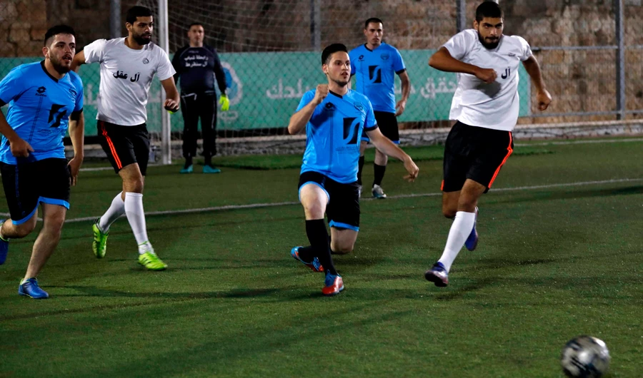 Palestinian football players compete during a second-round match in a month-long tournament pitting together Jerusalem's largest Palestinian families, in the Burj Luqluq part of Jerusalem's Old City on September 17, 2018. (AFP / AHMAD GHARABLI)