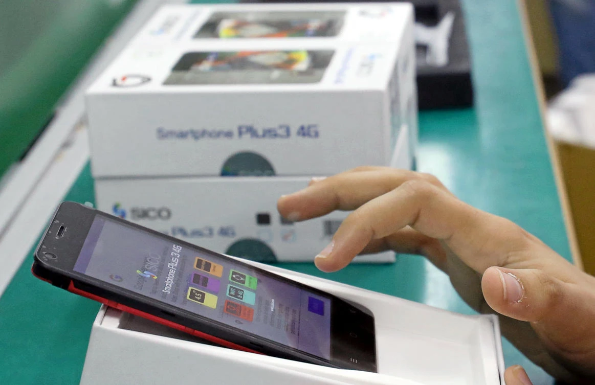 A worker tests mobile phone features in Assuit, Egypt September 30, 2018. Picture taken September 30, 2018. (Reuters)