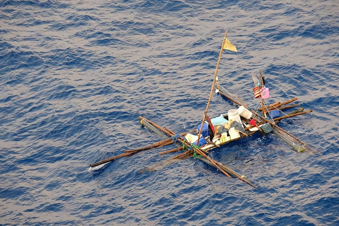 A makeshift bamboo raft was lashed together by five Philippine fishermen, whose boat was sunk by a marlin, before being rescued by the USS Wally Schirra in the South China Sea. (US Navy Seventh Fleet / AFP)