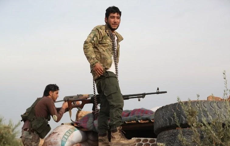 Fighters from the National Liberation Front at the frontline with regime forces inside the demilitarized zone southeast of Idlib province. (AFP)