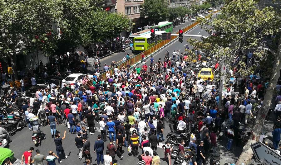 In this June 25, 2018 photo, Iranian protesters gather at Mobile market in Tehran to protest against the worsening economic crisis. (AFP file photo)