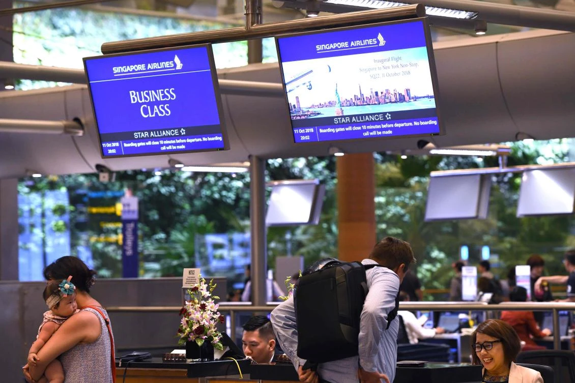 Passengers of flight SQ22, Singapore Airlines’ inaugural non-stop flight to New York check-in at Changi International Airport in Singapore. (AFP)