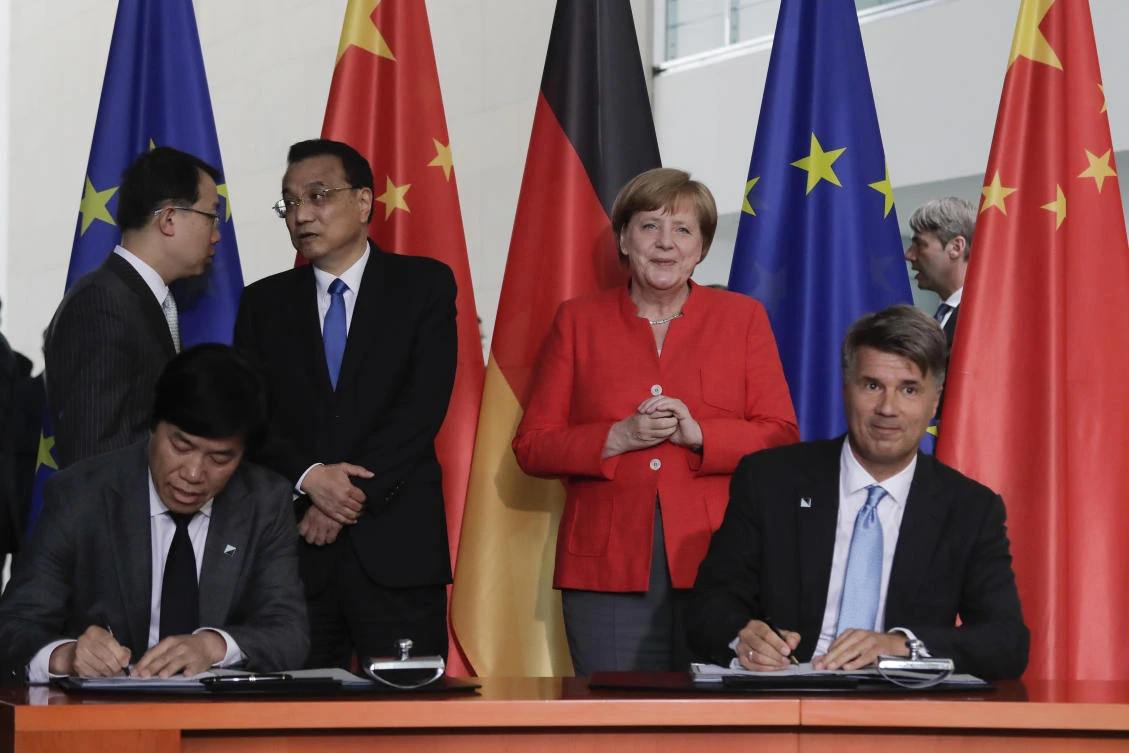 BMW CEO Harald Krueger, right, underlined the importance of China to the German automaker, saying the country, with its increased demand for electric vehicles, is a dynamic growth market for his country. (AP Photo)