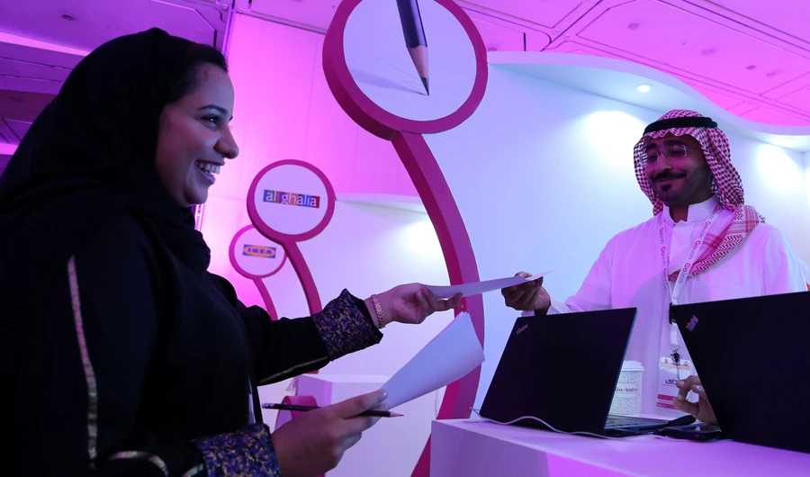 A Saudi female job seeker talks to a company representative. (Reuters)