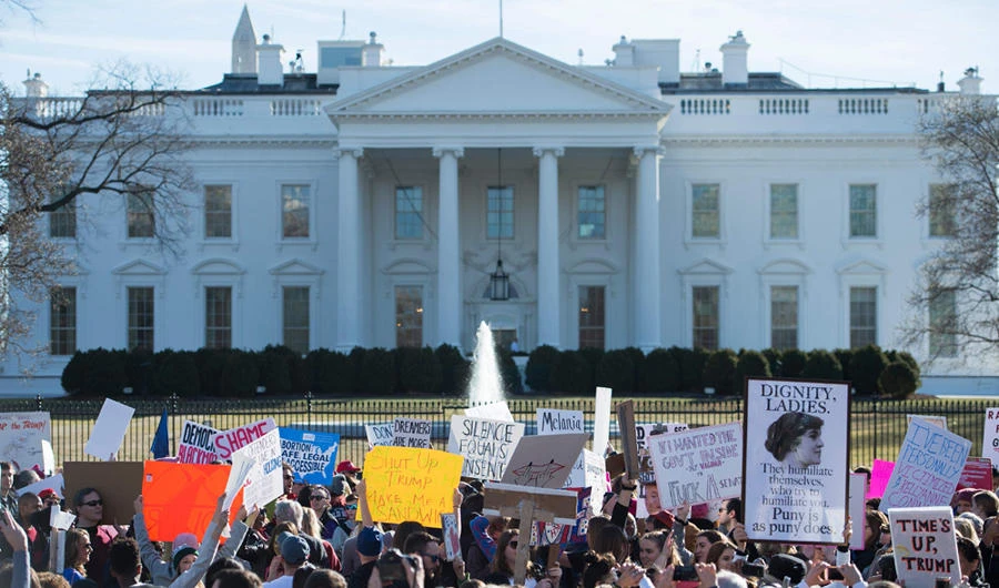 In this file photo taken on January 20, 2018 protesters hold up a sign near the White House following the Women's March on Washington 2018: March On The Polls! on the National Mall in Washington DC. Energized by a bitter fight over a US Supreme Court justice nominee, thousands of women were expected to march Saturday in Chicago and cast early midterm election ballots against the "anti-woman agenda" of President Donald Trump's administration. (AFP / ANDREW CABALLERO-REYNOLDS)
