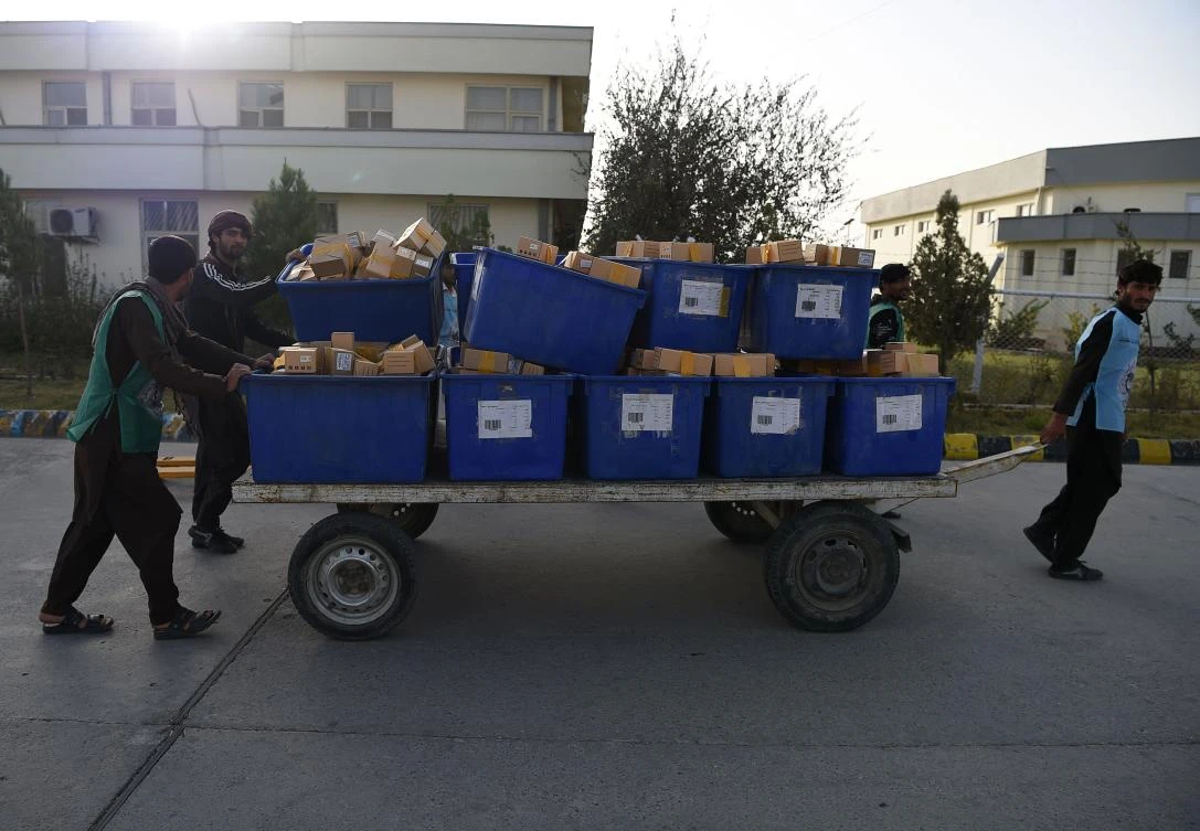 Election workers pull a cart loaded with biometric devices in Kabul. (AFP)