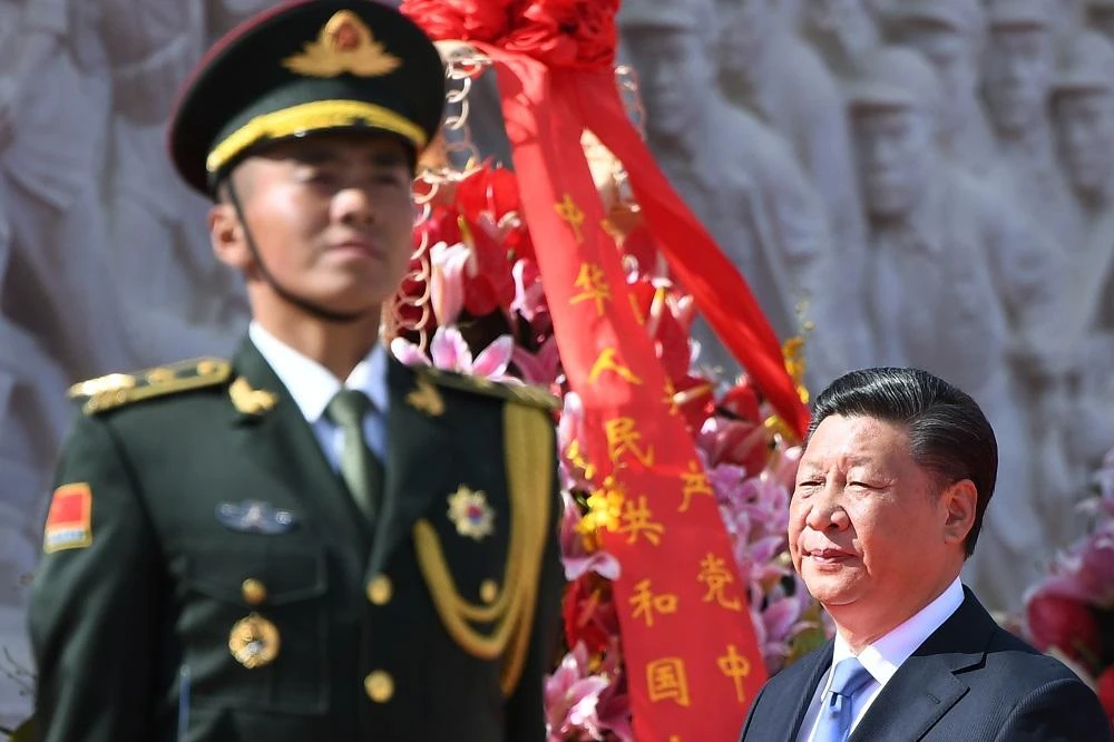 Chinese President Xi Jinping walks past a soldier. (File/AFP)