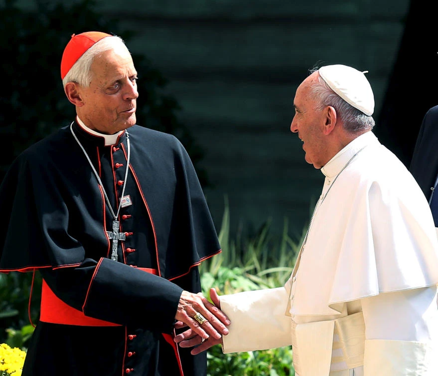 Pope Francis, right, greets the Archbishop of Washington Cardinal Donald Wuerl during the pope’s first visit to the US on September 2015. (Reuters)