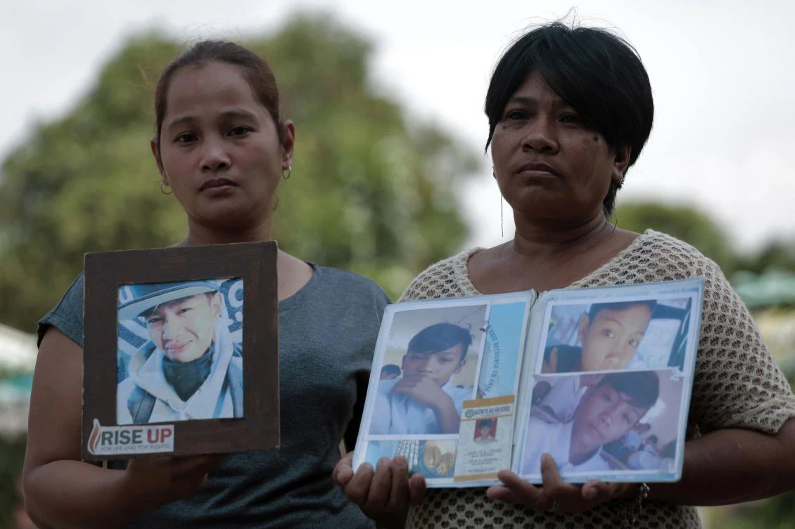 Former supporters of Philippine President Rodrigo Duterte’s drug war, holding pictures of their sons who they said were killed in police drug war operations. (AFP)