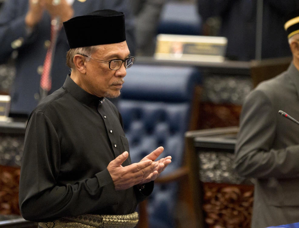 Malaysian politician Anwar Ibrahim prays during his swearing-in ceremony at the parliament in Kuala Lumpur, Malaysia, Monday, Oct. 15, 2018. (AP/Yam G-Jun)