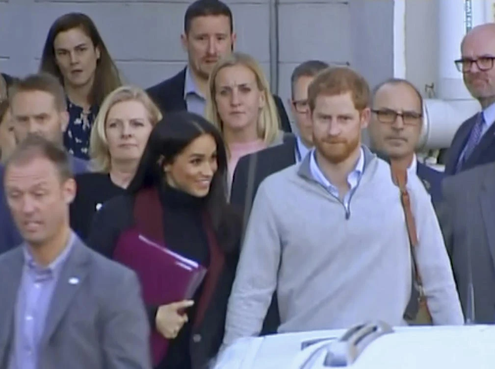 Britain’s Prince Harry, center right, and his wife Meghan, center left, Duke and Duchess of Sussex, approach a car at an airport in Sydney, Monday, Oct. 15, 2018. Prince Harry and his wife Meghan arrived in Sydney on Monday, a day before they officially start a 16-day tour of Australia and the South Pacific.(Australian Pool via AP)