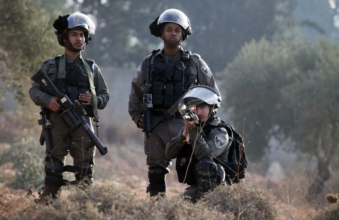 Members of the Israeli security forces take position during clashes over an Israeli order to shut down a Palestinian school in the town of as-Sawiyah, south of Nablus in the occupied West Bank on October 15, 2018. (AFP)