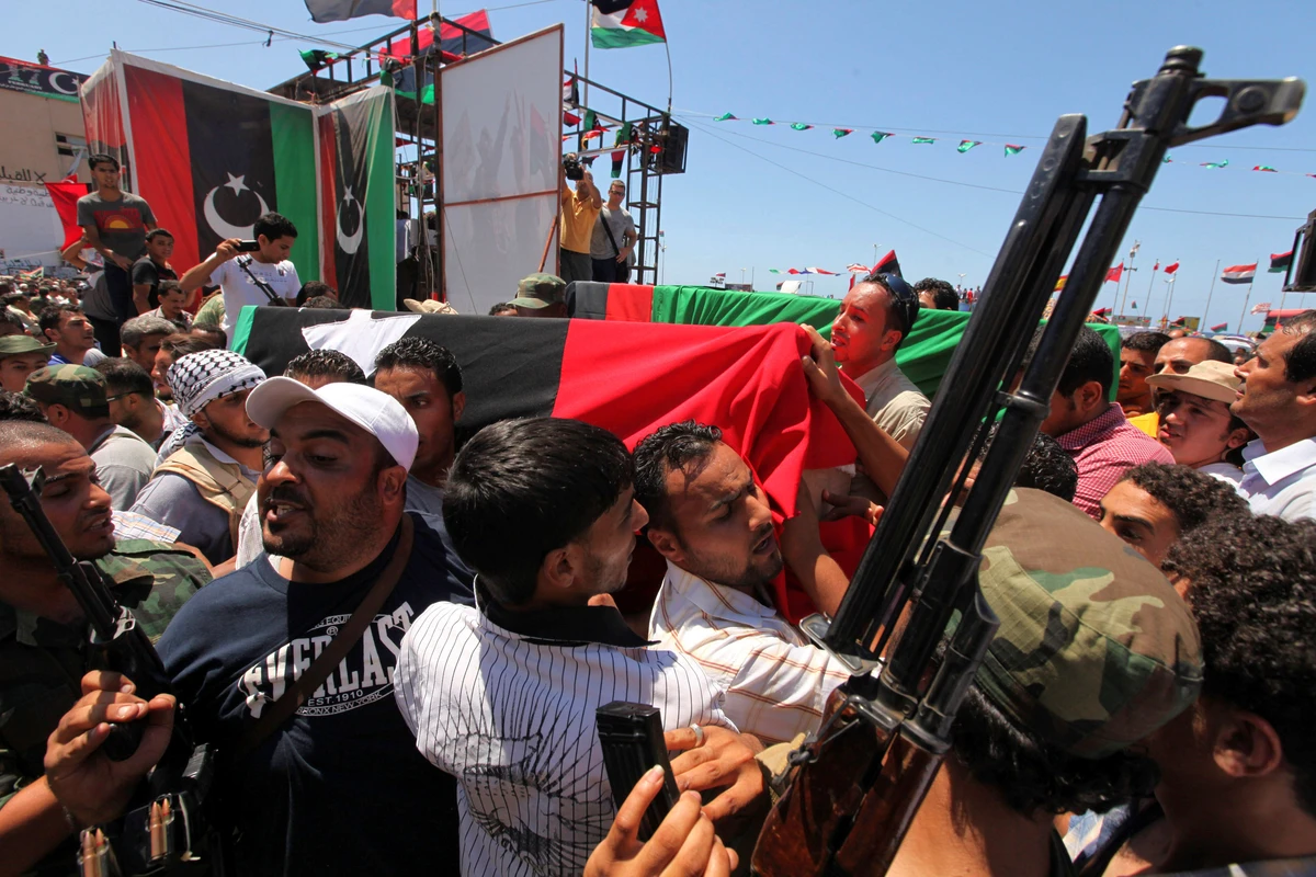 People attend the burial of Libya's rebel military commander Abdel Fattah Younes in Benghazi. (Reuters)