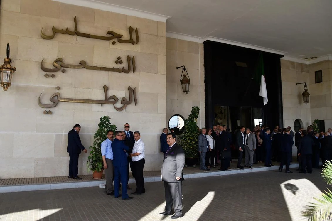 Algerian deputies from the National Liberation Front (FLN) and National Democratic Rally (RND) block the entrance of the National People's Congress in Algiers. AFP