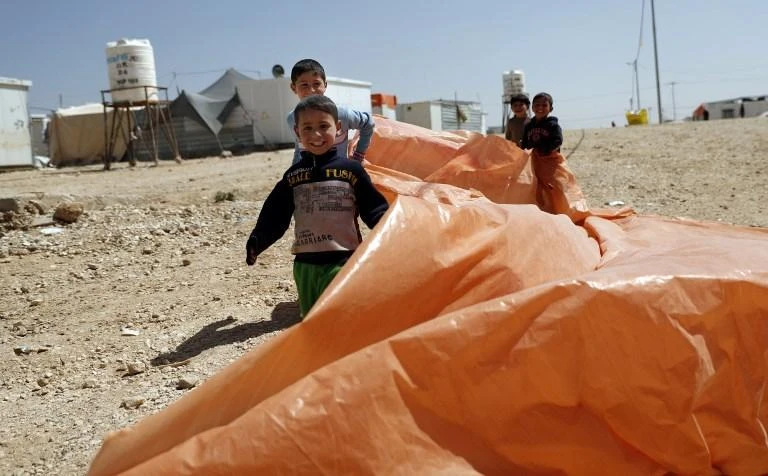 Children play at a camp which shelters refugees on the Jordanian border with war-ravaged Syria, in this March 28, 2017 photo. (AFP)